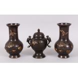 A GOOD GARNITURE OF JAPANESE BRONZE AND MIXED METAL, consisting of a pair of vases and a koro, all