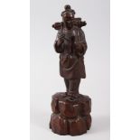 A GOOD CHINESE 19TH CENTURY HARDWOOD FIGURE OF A BOY, modeled holding a quill and scroll, his pack