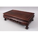 A CHINESE 19TH / 20TH CENTURY HUANGHUALI HARDWOOD LOW STAND, the frieze carved and pierced and stood