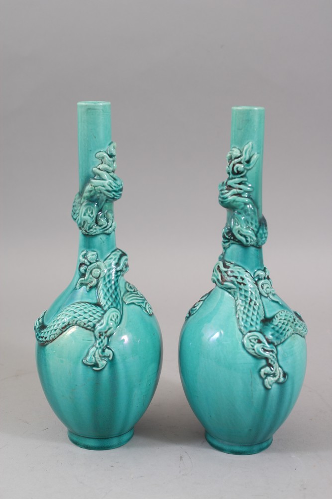 A PAIR OF ORIENTAL TURQUOISE GROUND PORCELAIN DRAGON BOTTLE VASES, both vase with moulded dragons - Image 2 of 6