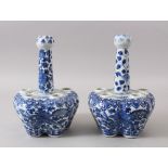 A PAIR OF 19TH CENTURY CHINESE BLUE & WHITE PORCELAIN TULIP HEAD BOTTLE VASES, both decorated with