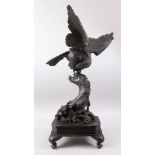 A JAPANESE MEIJI PERIOD SOLID BRONZE HAWK / EAGLE & DRAGON OKIMONO ON BRONZE BASE, the solid