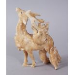 A JAPANESE MEIJI PERIOD CARVED IVORY OKIMONO OF MONKEY AND STAG, the stag modeled with five