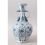 A CHINESE BLUE & WHITE MING STYLE PORCELAIN TWIN HANDLE VASE, the body of the vase with formal lotus