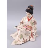 A JAPANESE LATE MEIJI PERIOD SATSUMA FIGURE OF A GEISHA, modeled in a seated reclined position