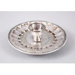 AN 18TH CENTURY MUGHAL INDIAN SILVER CIRCULAR CHAMBER CANDLESTICK, 13cm diameter.