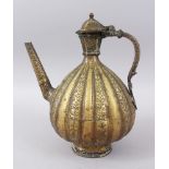 AN 18TH-19TH CENTURY INDIAN BRASS EWER, 28cm high.