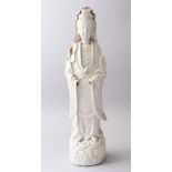 A 18TH / 19TH CENTURY CHINESE BLANC DE CHINE FIGURE OF GUANYIN, stood upon a stylized wave base in