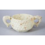 A 20TH CENTURY CHINESE ARCHAIC STYLE JADE / SOAPSTONE MING STYLE CUP, 13.5cm wide including handles,