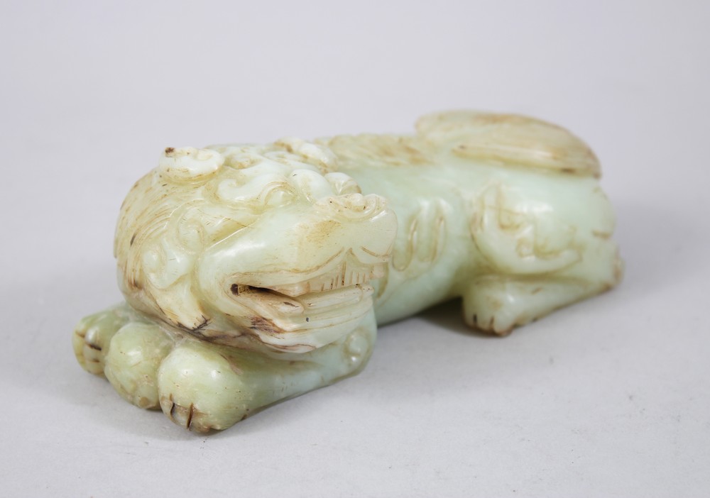 A GOOD 19TH / 20TH CENTURY CHINESE CARVED JADE LION DOG, the dog recumbent, 5.5cm high x 16cm wide.