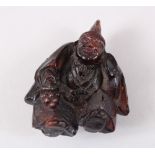 AN 18TH CENTURY CHINESE AMBER CARVED FIGURE OF A SAGE, dressed in traditional attire carved with