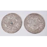 A PAIR OF 19TH CENTURY SINO TIBETAN SILVER PLAQUES FOR CEREMONY ROBES, the plaques with pressed
