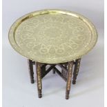 A 19TH-20TH CENTURY ISLAMIC PERSIAN QAJAR HAND CHISELLED BRASS CIRCULAR TRAY on an ivory inlaid