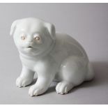 A JAPANESE MEIJI PERIOD HIRADO PORCELAIN MODEL OF AN AKITA PUPPY, modeled in a seated position, 10cm