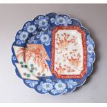 A JAPANESE MEIJI PERIOD IMARI DECORATED BLUE & WHITE PORCELAIN PLATE, with scalloped edge and