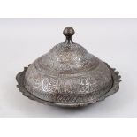 A 19TH CENTURY TURKISH WHITE METAL SERVING DISH AND COVER, with script and floral decoration, 13.5cm