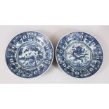 A PAIR OF CHINESE BLUE & WHITE KRAAK PORCELAIN PLATES, with decoration of dragons amongst waves, and