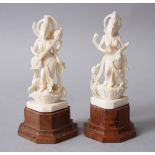 A SMALL PAIR OF 19TH CENTURY INDIAN CARVED IVORY DEITIES, both pinned on wooden bases. 12cm high x