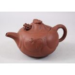 A CHINESE 20TH CENTURY CHINESE YIXING CLAY TEAPOT, with moulded panels of mythical beasts, the lid