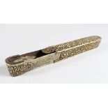 A 19TH-20TH CENTURY PERSIAN QAJAR QALAMDAN OPEN WORK BRASS PEN BOX with inkwell, 22cm long.