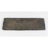 A 19TH CENTURY INDIAN OR TIBETAN WOODEN PRINTING BLOCK with calligraphy on each side, 33cm long,