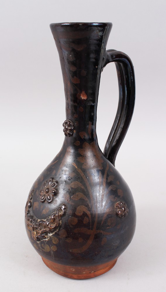 A 19TH CENTURY OTTOMAN TURKISH CANAKKALE BROWN GLAZED JUG, 33cm high.