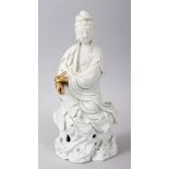 AN 18TH / 19TH CENTURY CHINESE BLANC DE CHINE PORCELAIN FIGURE OF GUANYIN, seated upon a rock formed