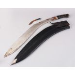 A LARGE NEPALESE KUKRI in a leather scabbard with small knife.