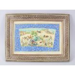 A PERSIAN PAINTING ON IVORY, tents, figures on camels and cows, 10cm x 20cm in a mosaic frame.