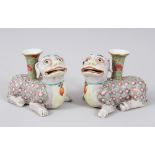 A PAIR OF 19TH CENTURY CHINESE EXPORT CANTON PORCELAIN DOG CANDLESTICKS, modeled as recumbent lion