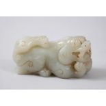 A GOOD 18TH / 19TH CENTURY CARVED JADE / NEPHRITE KYLIN, carved bearing its teeth with young upon