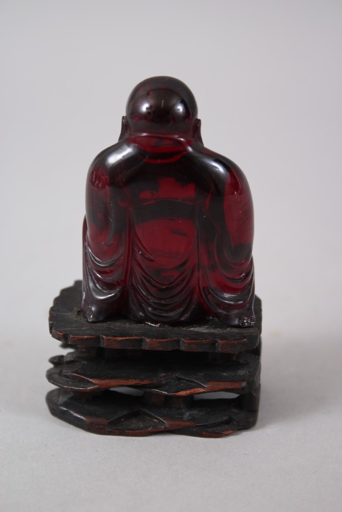 A GOOD 19TH CENTURY CHINESE CHERRY AMBER CARVED FIGURE OF BUDDHA, seated upon a carved and pierced - Image 3 of 4