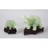 TWO 20TH CENTURY CHINESE JADE ELEPHANT FIGURES WITH BASES, each elephant in a striding pose and