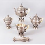 A SUPERB BURMESE SILVER FIVE PIECE TEA SET, with all-over decoration and ivory handles, comprising