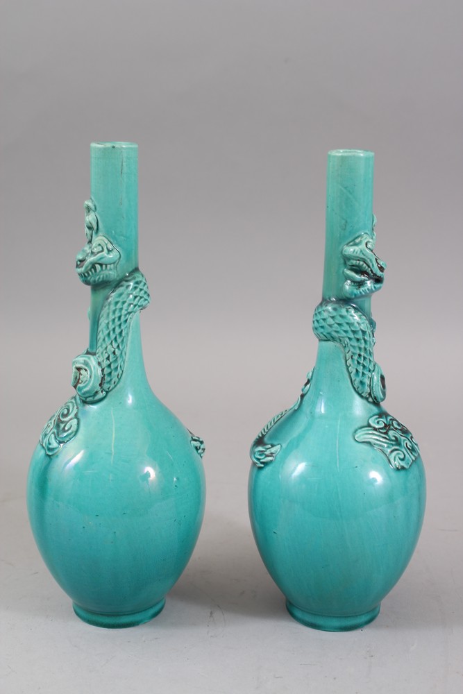 A PAIR OF ORIENTAL TURQUOISE GROUND PORCELAIN DRAGON BOTTLE VASES, both vase with moulded dragons - Image 3 of 6