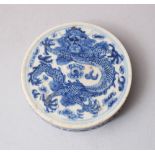 A 19TH CENTURY CHINESE BLUE & WHITE PORCELAIN DRAGON INK BOX LID, 6.2cm diameter.