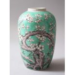 A GOOD 19TH CENTURY CHINESE KANGXI STYLE GREEN GROUND PORCELAIN VASE, the body depicting birds