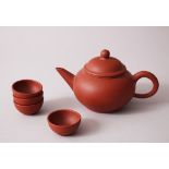 A GOOD CHINESE YIXING CLAY TEAPOT & FOUR TEA BOWLS, each of the tea bowls bearing a four character