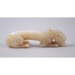 A GOOD CHINESE 18TH / 19TH CENTURY CARVED JADE KYLIN, carved in resting pose, 2.8cm high x 8.5cm