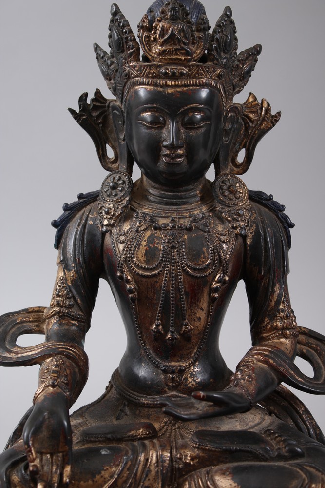 A CHINESE GILT BRONZE FIGURE OF A BUDDHA, seated upon a lotus formed base in a meditating position, - Image 2 of 7