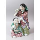 A GOOD REPLUBLICAN PERIOD FAMILLE ROSE PORCELAIN GROUP FIGURE OF HE HE, the scene of two boys