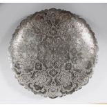 A PERSIAN ISPHAHAN WHITE METAL ENGRAVED DISH on three ball feet, 24cm diameter.