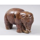 A JAPANESE MEIJI PERIOD STUDIO POTTERY ELEPHANT MONEY BOX, 14cm high x 23cm long.