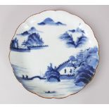 A JAPANESE EDO PERIOD ARITA BLUE & WHITE LOBED PORCELAIN DISH, with decorations mountains, temples