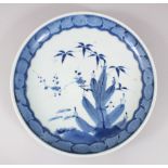 A JAPANESE MEIJI PERIOD BLUE & WHITE ARITA PORCELAIN DISH, decorated with scenes of foliage, the