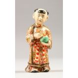 A JAPANESE SATSUMA MODEL OF A BOY, stood holding a jar, wearing traditional attire, signed to the