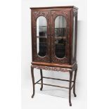 A GOOD 19TH CENTURY CHINESE HARDWOOD CARVED DISPLAY CABINET, the body of the cabinet carved in