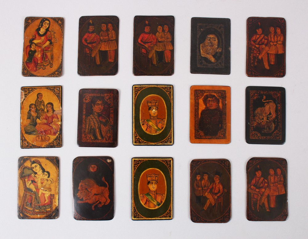 A COLLECTION OF FIFTEEN 19TH CENTURY PERSIAN QAJAR LACQUER PAPIER MACHE PLAYING CARDS