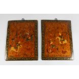 A PAIR OF 19TH CENTURY QAJAR HAND PAINTED BOOK COVERS, deer hunting, 26cm x 19cm.