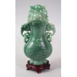 A 20TH CENTURY CHINESE CARVED JADE LIDDED VASE & STAND, the vase with a lion dog handled lid, with